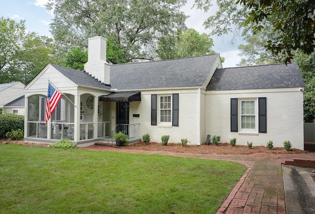 3117 Bransford Rd, Augusta, GA 30909 - ranch-style house with brick siding, a front lawn, a chimney, a sunroom, and a shingled roof
