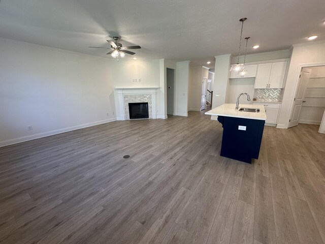 empty room featuring light carpet, a tray ceiling, crown molding, and baseboards