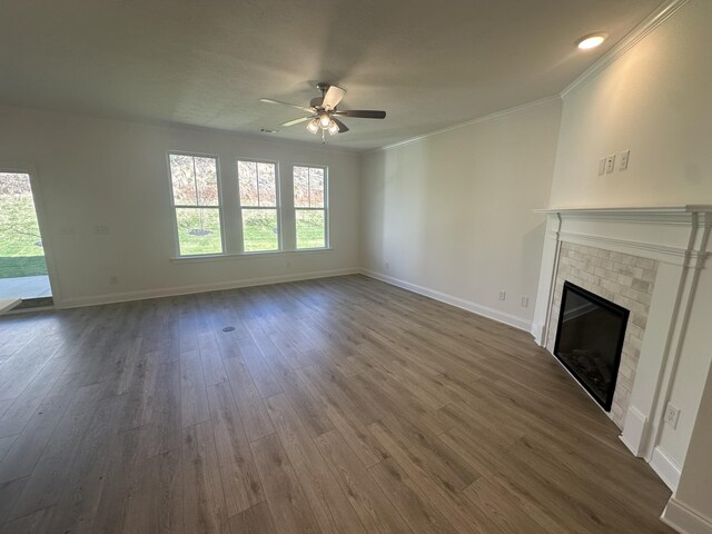 unfurnished living room featuring a brick fireplace, baseboards, and dark wood-type flooring