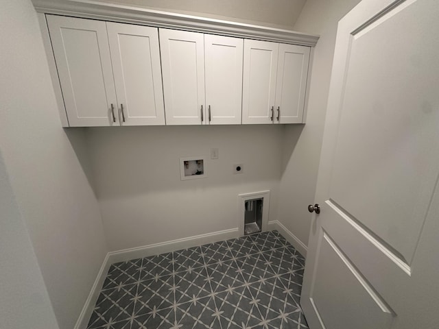 laundry area with dark floors, cabinet space, electric dryer hookup, and baseboards