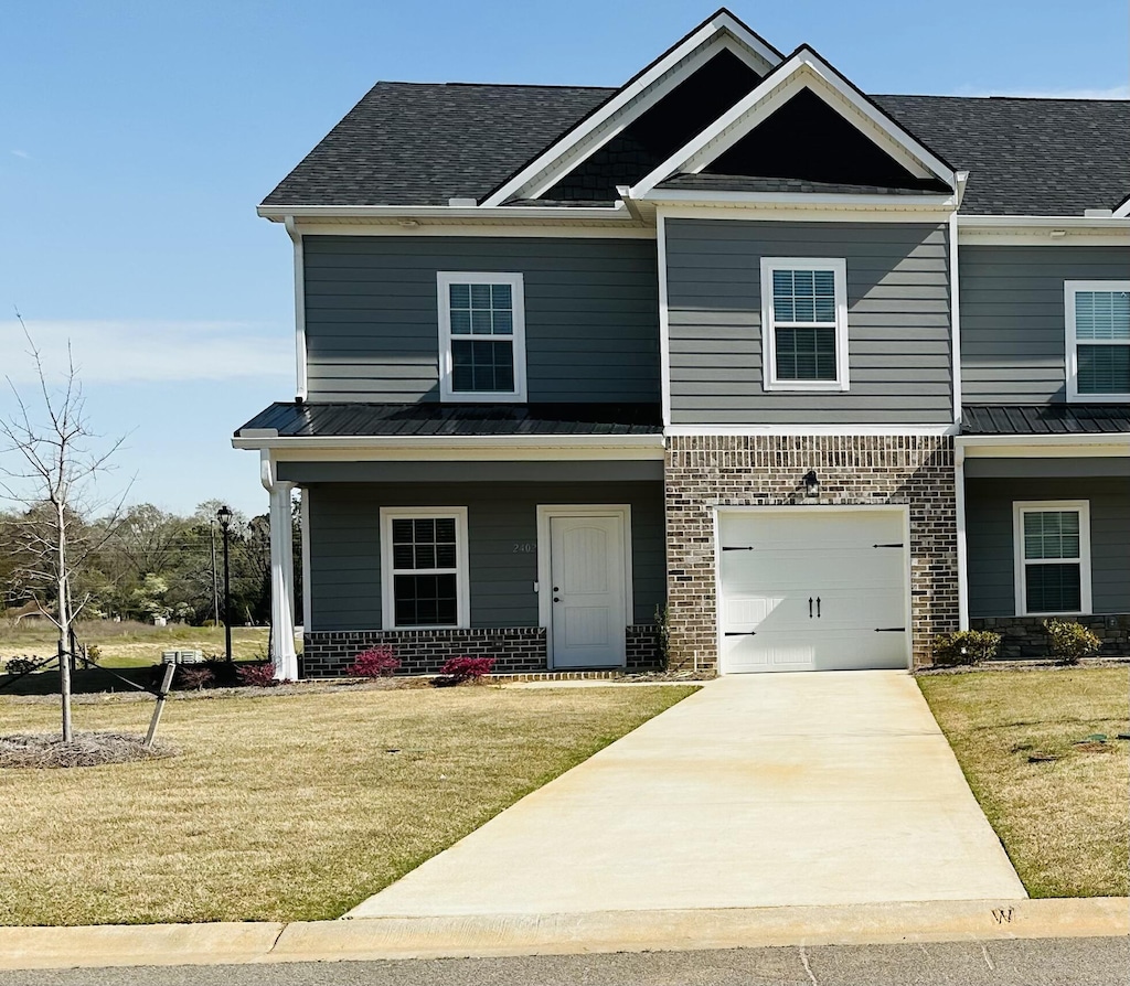 view of front of home with a front lawn and a garage