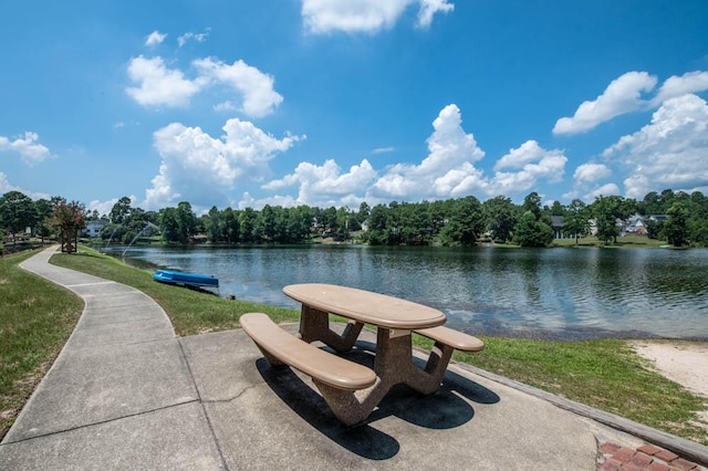 view of property's community featuring a water view and a lawn