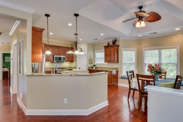 136 Lake Ridge Dr, Mccormick, SC 29835 - kitchen with appliances with stainless steel finishes, ceiling fan, brown cabinetry, dark wood-style flooring, and crown molding