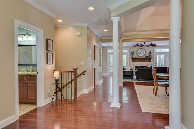 136 Lake Ridge Dr, Mccormick, SC 29835 - entryway with a fireplace, decorative columns, dark wood-style flooring, crown molding, and ceiling fan