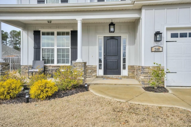 property entrance with a garage and covered porch