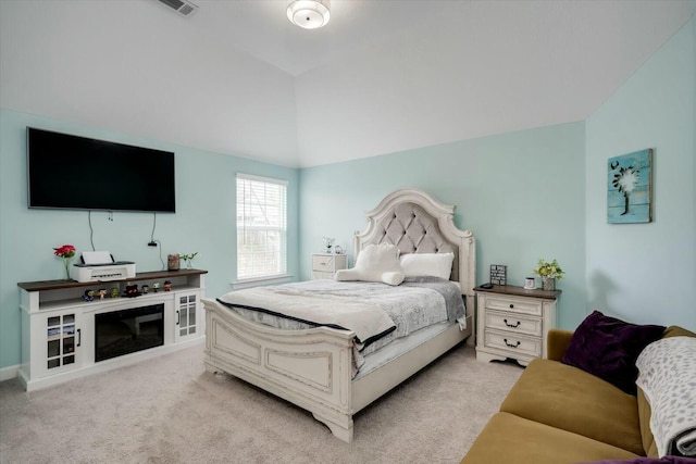 carpeted bedroom featuring vaulted ceiling