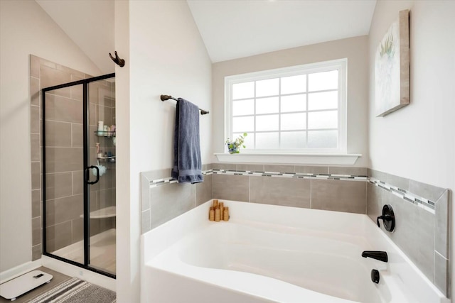 bathroom with independent shower and bath and vaulted ceiling