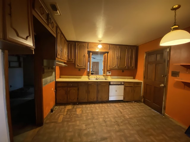 kitchen with sink, decorative light fixtures, light parquet flooring, and dishwasher