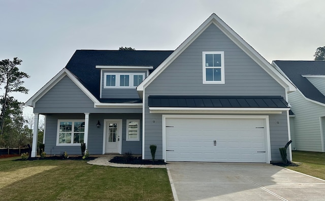 view of front of home featuring a garage, a standing seam roof, driveway, and a front lawn