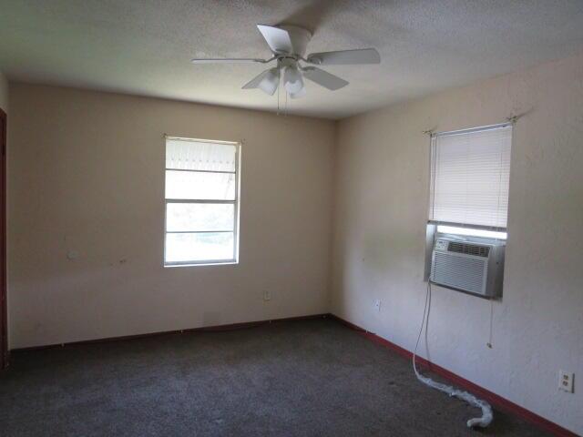 1466 Dewitt St, Augusta, GA 30901 - carpeted empty room with a ceiling fan and cooling unit