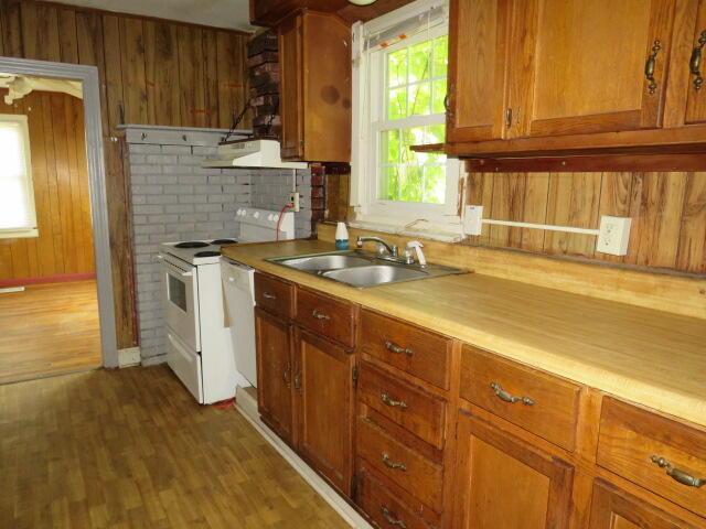1466 Dewitt St, Augusta, GA 30901 - kitchen featuring brown cabinets, white appliances, ventilation hood, wood finished floors, and light countertops