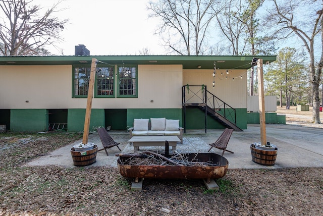 back of property featuring a fire pit