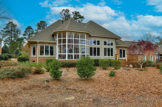 rear view of property featuring a sunroom