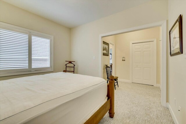 bedroom featuring light colored carpet