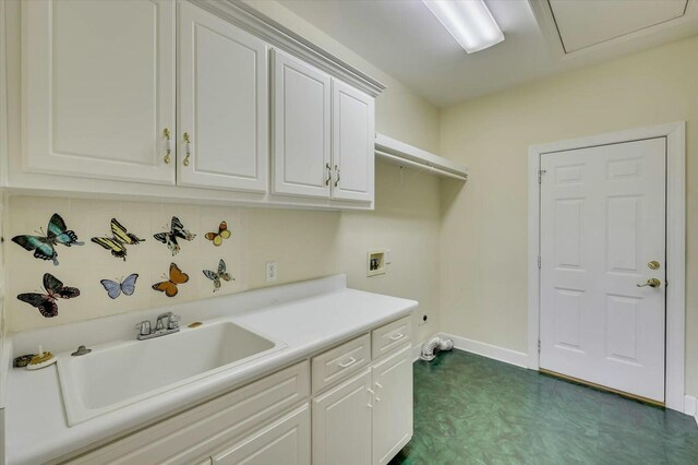 laundry room with cabinets, hookup for a washing machine, and sink