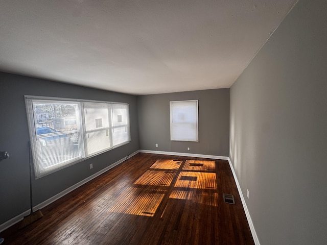 unfurnished room featuring dark hardwood / wood-style flooring