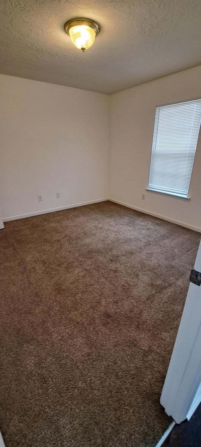231 Lynbrook Way, Grovetown, GA 30813 - spare room featuring dark colored carpet, a textured ceiling, and baseboards
