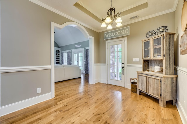 492 Knob Hill Ct, Evans, GA 30809 - entryway featuring light wood-type flooring, a chandelier, a wainscoted wall, a tray ceiling, and crown molding