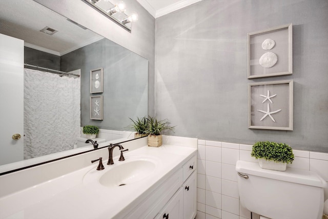 full bath featuring ornamental molding, toilet, vanity, and tile walls