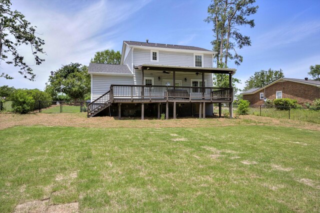 back of property with a wooden deck, a ceiling fan, and stairs