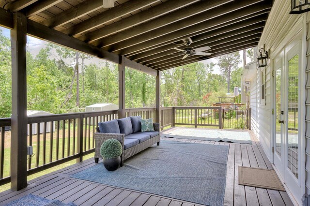 deck featuring outdoor lounge area and french doors