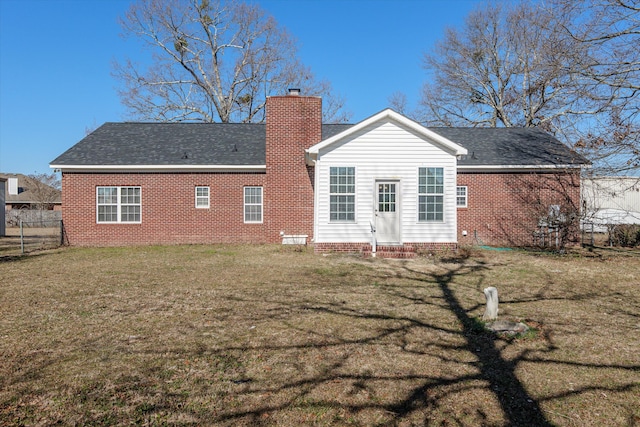 back of house with a lawn