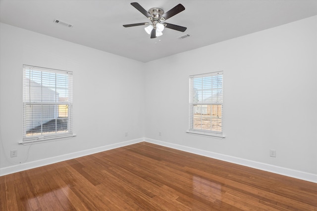 empty room featuring wood-type flooring and ceiling fan