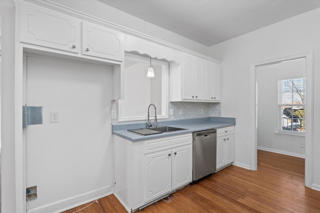 kitchen with sink, dark wood-type flooring, white cabinetry, decorative light fixtures, and stainless steel dishwasher