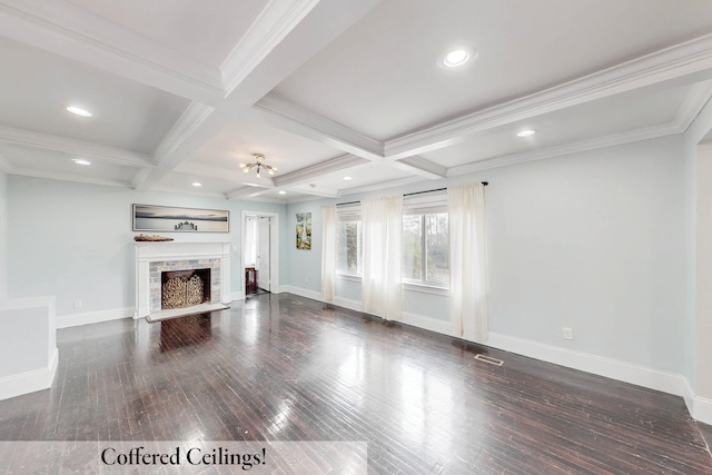 unfurnished living room with coffered ceiling, beam ceiling, ornamental molding, and dark hardwood / wood-style floors