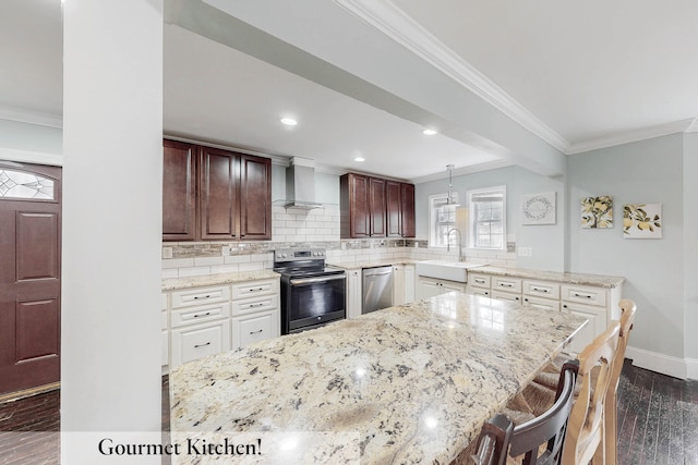 kitchen featuring appliances with stainless steel finishes, sink, dark hardwood / wood-style flooring, a kitchen breakfast bar, and wall chimney range hood