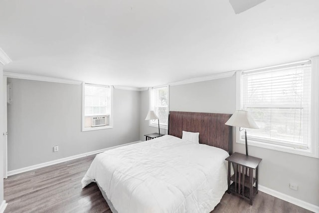 bedroom with dark wood-type flooring, ornamental molding, and cooling unit