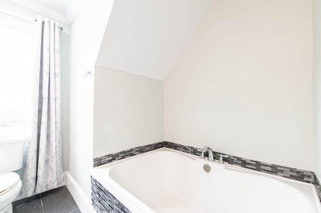 bathroom featuring ornamental molding, lofted ceiling, toilet, and tile patterned flooring