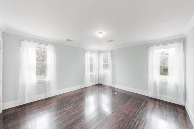 unfurnished room with dark wood-type flooring and ornamental molding