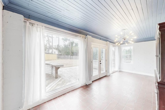 unfurnished sunroom with wood ceiling, french doors, and a notable chandelier