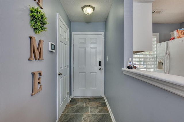 entryway with a textured ceiling