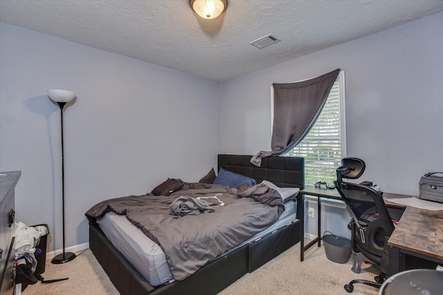 carpeted bedroom featuring a textured ceiling