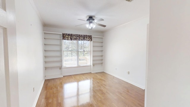 4154 Bent Tree Ln, Martinez, GA 30907 - spare room with crown molding, a ceiling fan, light wood-type flooring, built in shelves, and baseboards