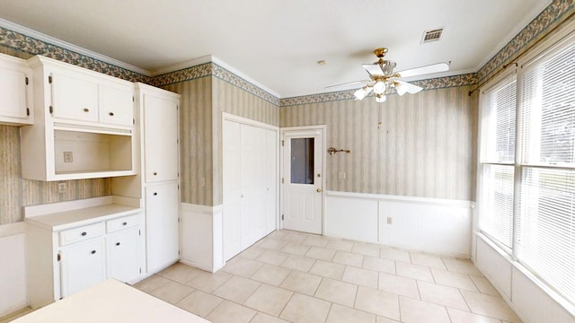 4154 Bent Tree Ln, Martinez, GA 30907 - kitchen with wallpapered walls, a wainscoted wall, ceiling fan, white cabinetry, and ornamental molding