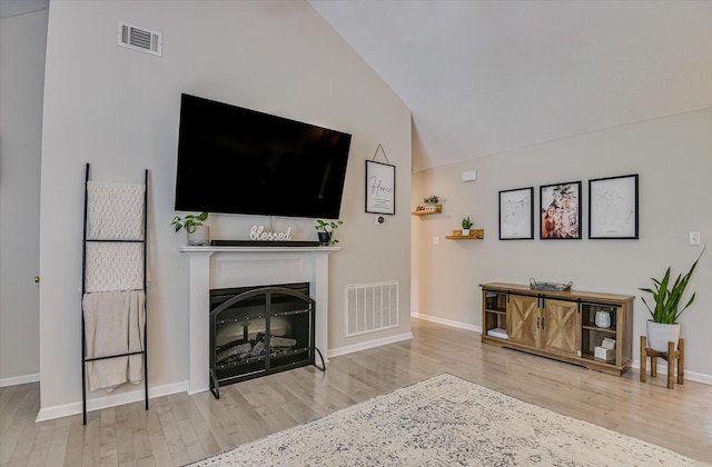 841 High Green Ct, Grovetown, GA 30813 - living room featuring wood finished floors, vaulted ceiling, and a fireplace