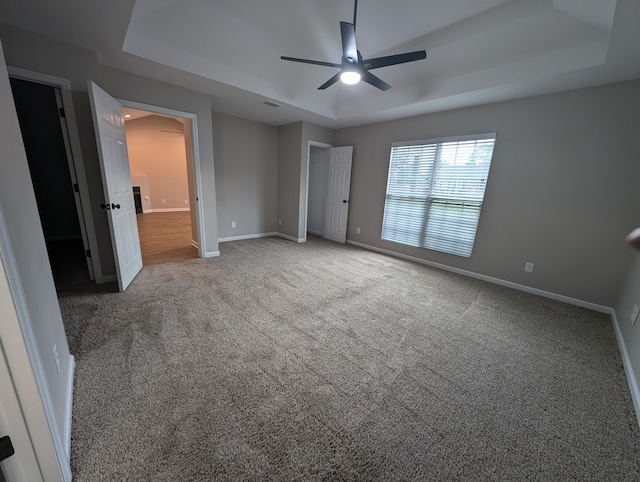 4331 Big Dipper Cir, Hephzibah, GA 30815 - unfurnished bedroom with a tray ceiling, carpet, and a ceiling fan