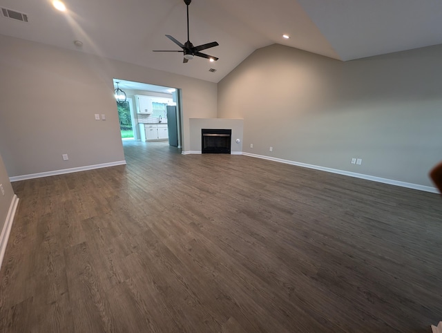 4331 Big Dipper Cir, Hephzibah, GA 30815 - unfurnished living room with ceiling fan, dark wood-style flooring, vaulted ceiling, a fireplace, and recessed lighting