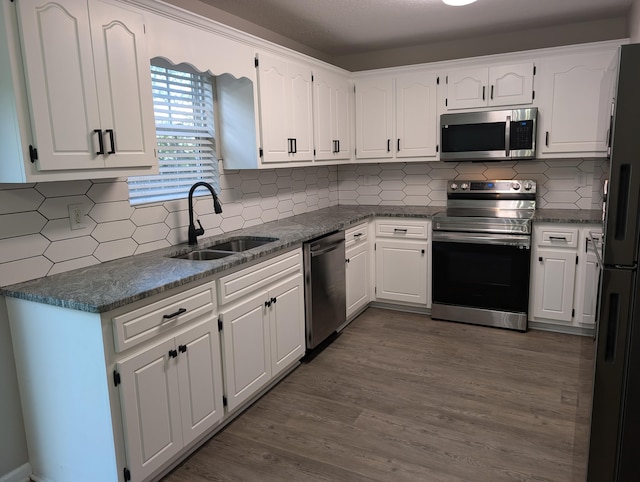 4331 Big Dipper Cir, Hephzibah, GA 30815 - kitchen with appliances with stainless steel finishes, dark countertops, and white cabinetry