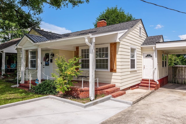 1216 Heard Ave, Augusta, GA 30904 - bungalow with entry steps, roof with shingles, a chimney, a carport, and covered porch
