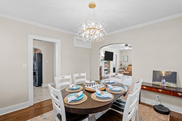 1216 Heard Ave, Augusta, GA 30904 - dining area featuring arched walkways, wood finished floors, ornamental molding, a chandelier, and a ceiling fan