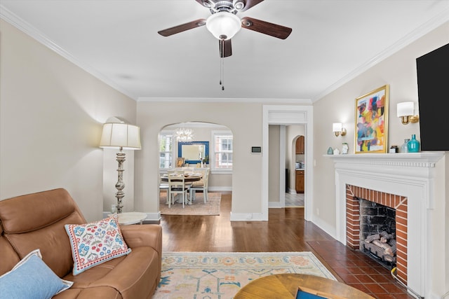 1216 Heard Ave, Augusta, GA 30904 - living room featuring arched walkways, ornamental molding, wood finished floors, a ceiling fan, and a fireplace