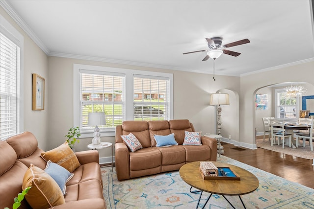 1216 Heard Ave, Augusta, GA 30904 - living area featuring arched walkways, ornamental molding, wood finished floors, ceiling fan, and a chandelier