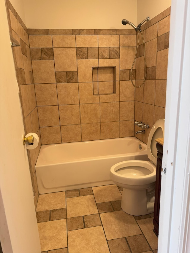 bathroom with tiled shower / bath combo and toilet