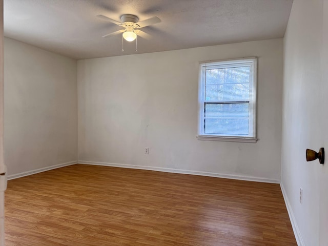 empty room featuring hardwood / wood-style flooring and ceiling fan