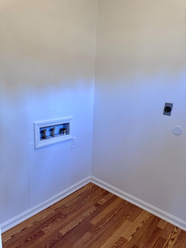 laundry area with hookup for an electric dryer, hookup for a washing machine, and hardwood / wood-style flooring