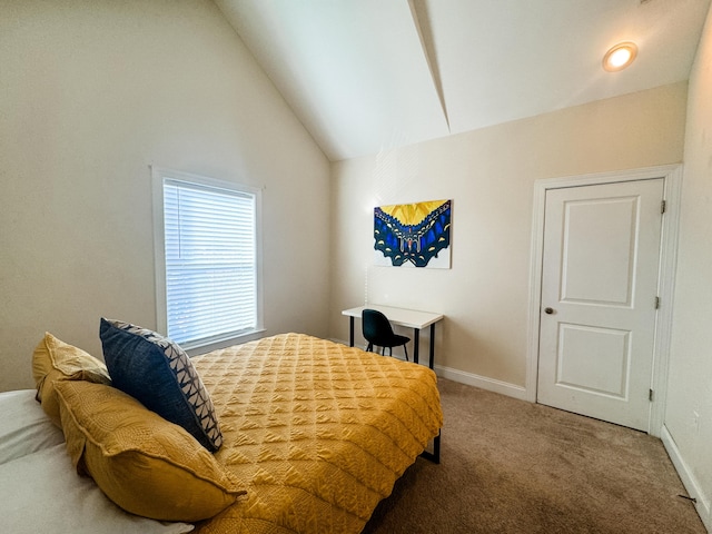 bedroom with carpet floors and vaulted ceiling